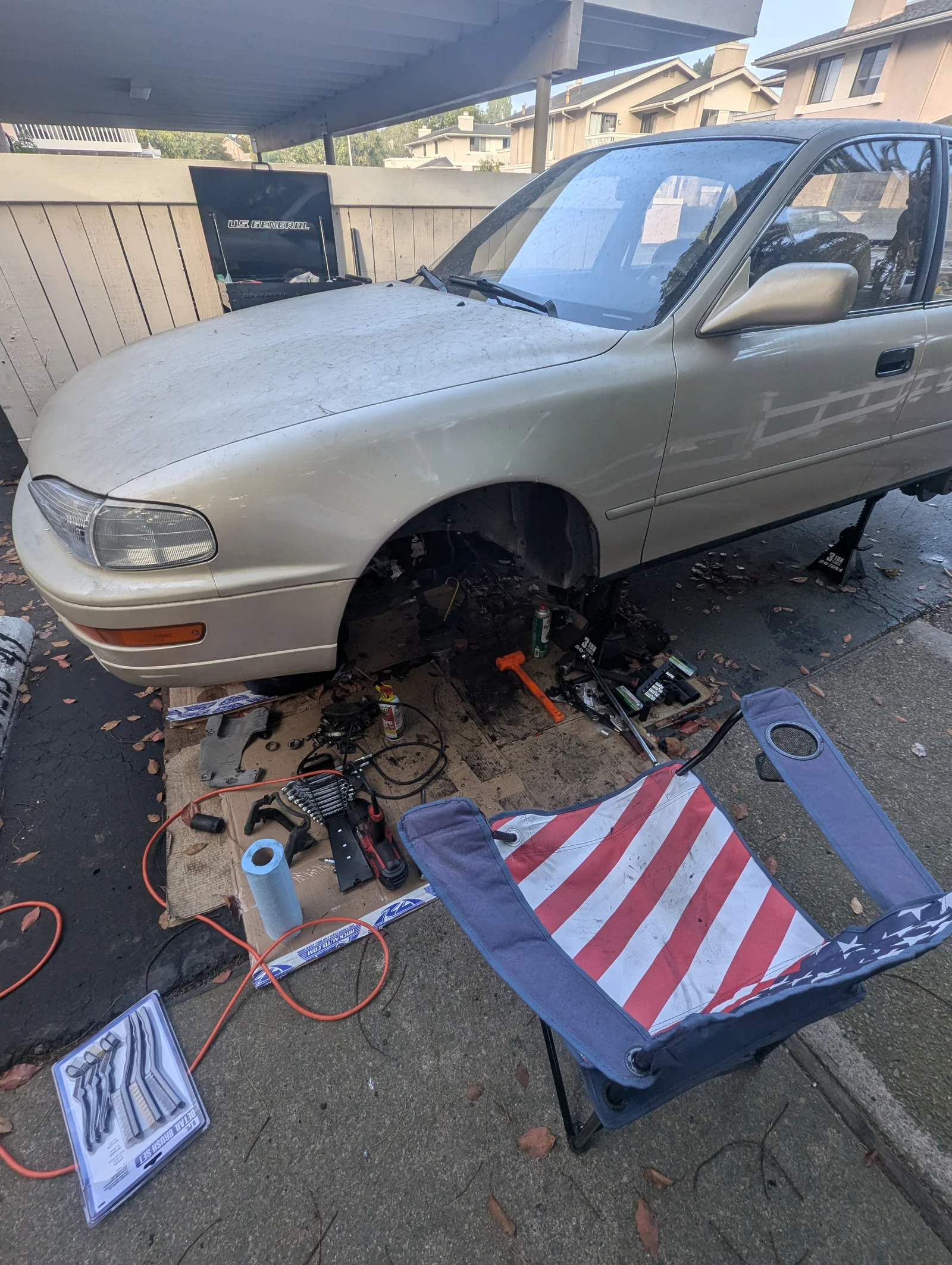 1993 Toyota Camry on stands with its front driver-side suspension removed